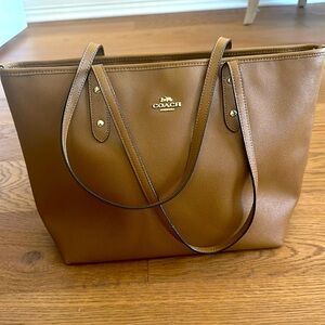 Like new Coach tote bag. Carried once. 17 inches wide, w/ inside zipper pocket.